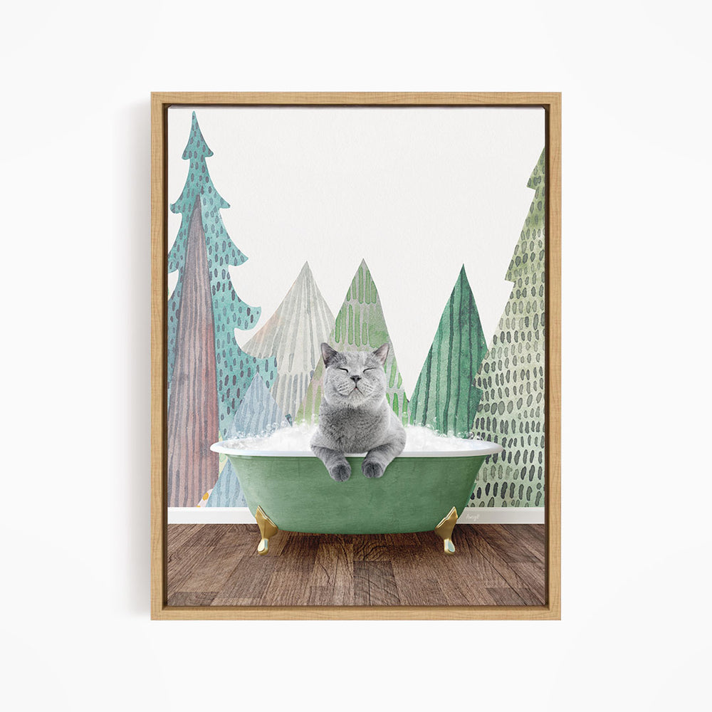 A gray cat sitting in a green bathtub, surrounded by a forest scene with trees and a snowy landscape.