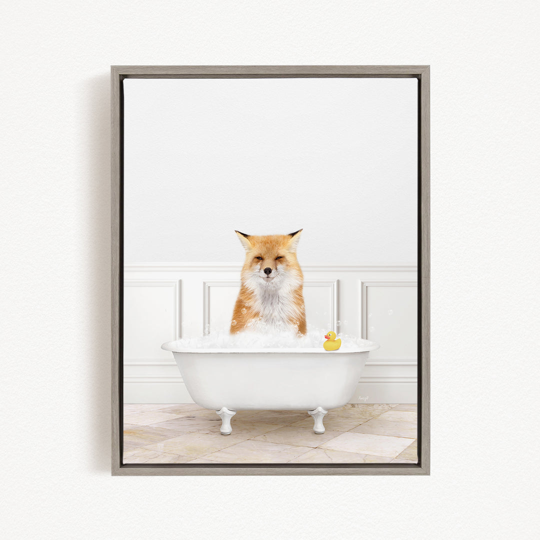 A red fox is sitting in a white bathtub filled with bubbles, with a rubber duck floating in the water.