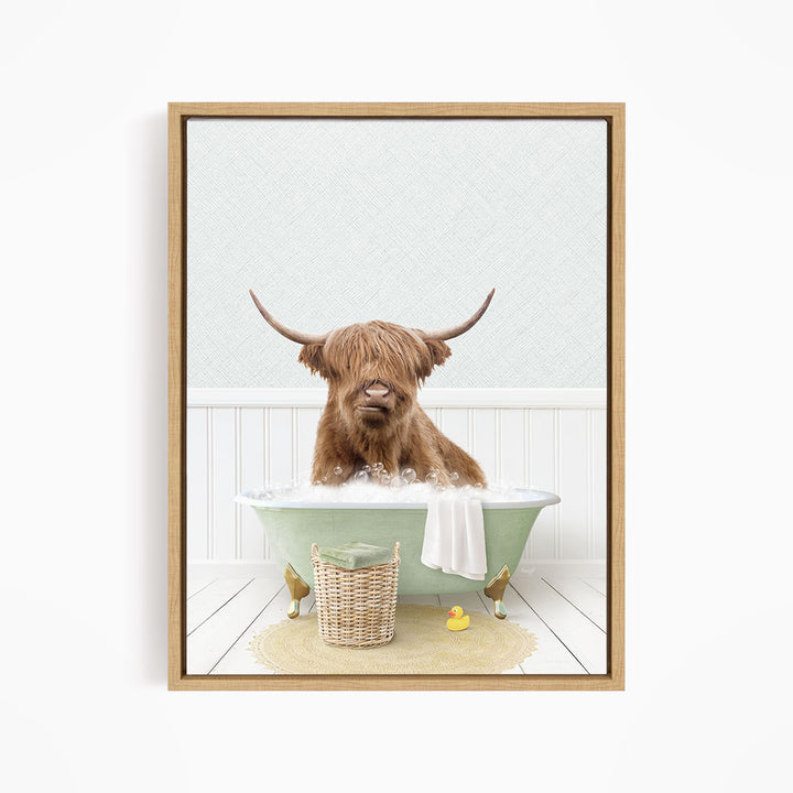 A brown cow with long horns is sitting in a green bathtub filled with water, surrounded by a basket of toys and a yellow rubber duck.