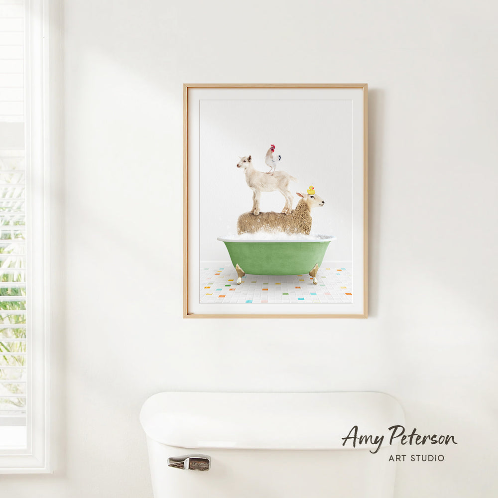 A framed print of a whimsical scene depicting a chicken perched on a sheep in a bathtub, with a toilet and a window in the background.