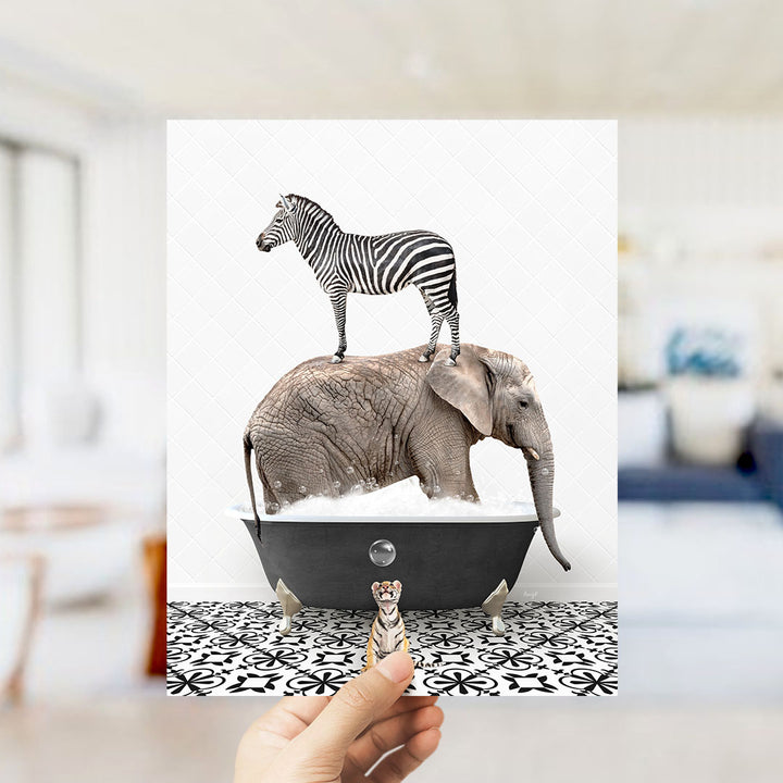 A hand holds up a collage of two images: a zebra standing on an elephant's back in a bathtub, and a small animal, likely a meerkat, standing in front of the elephant.