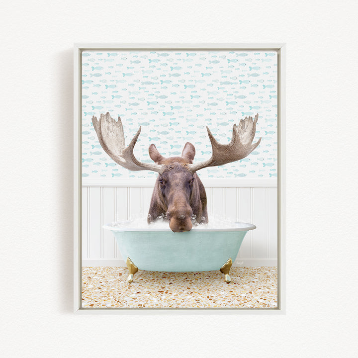 A moose with large antlers is sitting in a bathtub filled with water, surrounded by a pattern of fish.