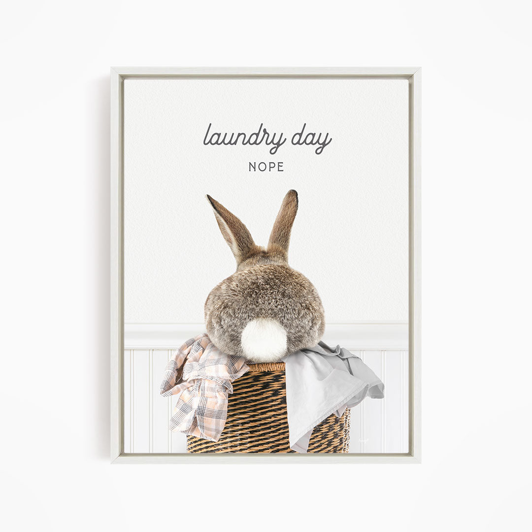 A rabbit sitting in a laundry basket, with the text "laundry day NOPE" above it.