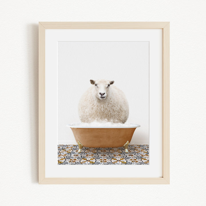 A fluffy white sheep sits in a brown bathtub filled with bubbles, surrounded by a patterned tile floor.