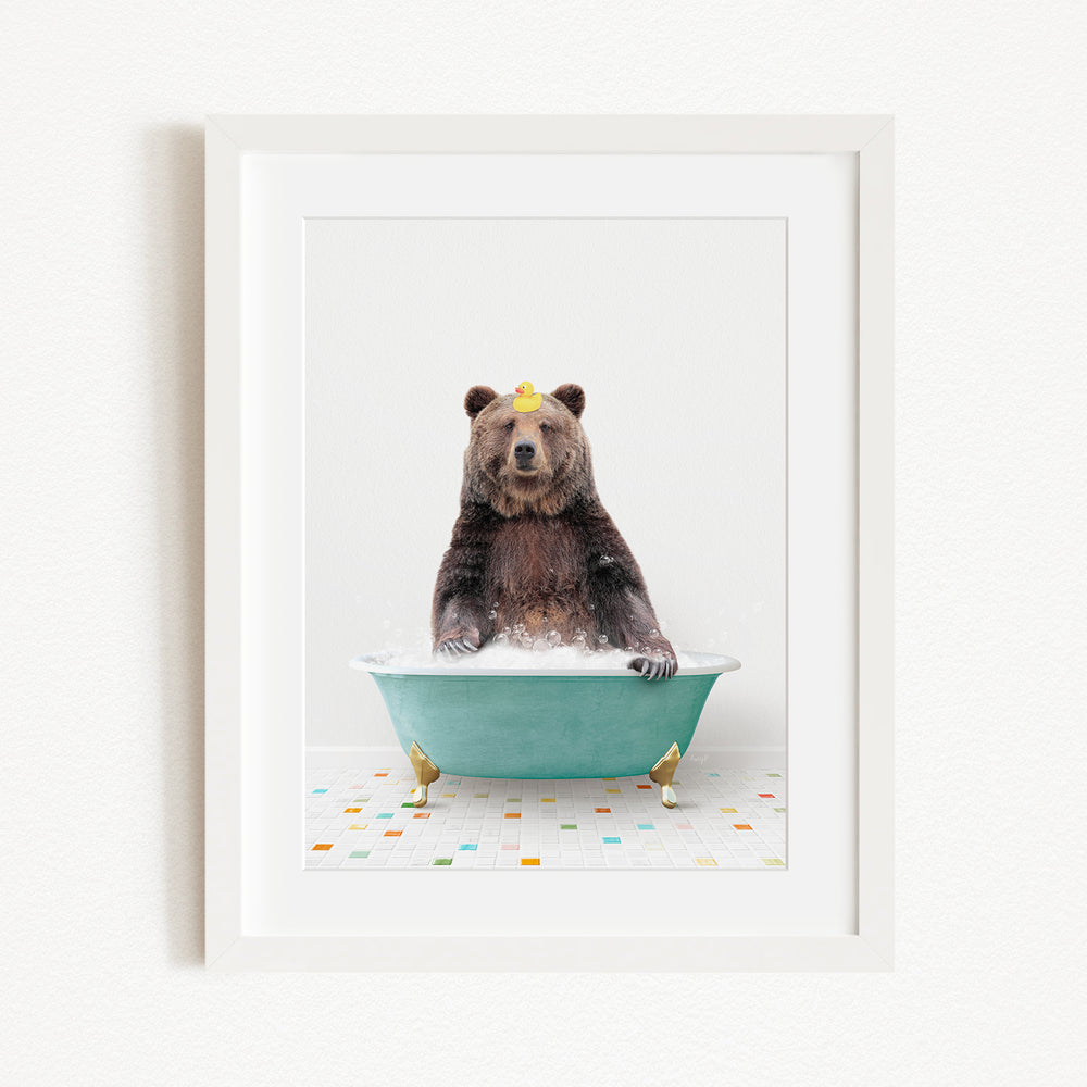 A brown bear sitting in a green bathtub filled with bubbles, with a yellow rubber duck floating on the water.