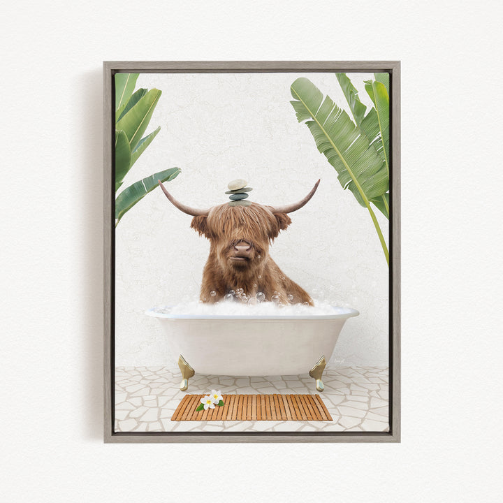 A brown cow with long horns is sitting in a white bathtub filled with bubbles, surrounded by green plants and a wooden mat on the floor.