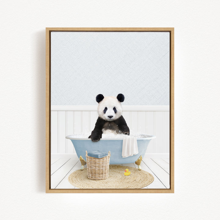 A panda bear sitting in a blue bathtub, surrounded by a basket of toys and a yellow rubber duck.