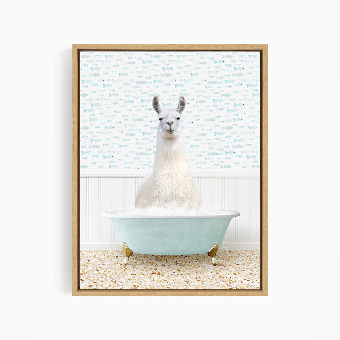 A white llama sitting in a light blue bathtub filled with bubbles, with a patterned wall behind it.