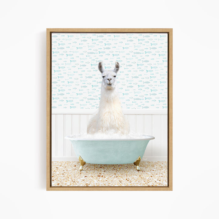 A white llama sitting in a light blue bathtub filled with bubbles, with a patterned wall behind it.