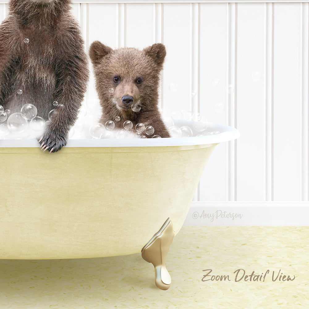 A baby bear sitting in a bathtub filled with bubbles, with another bear sitting next to it.