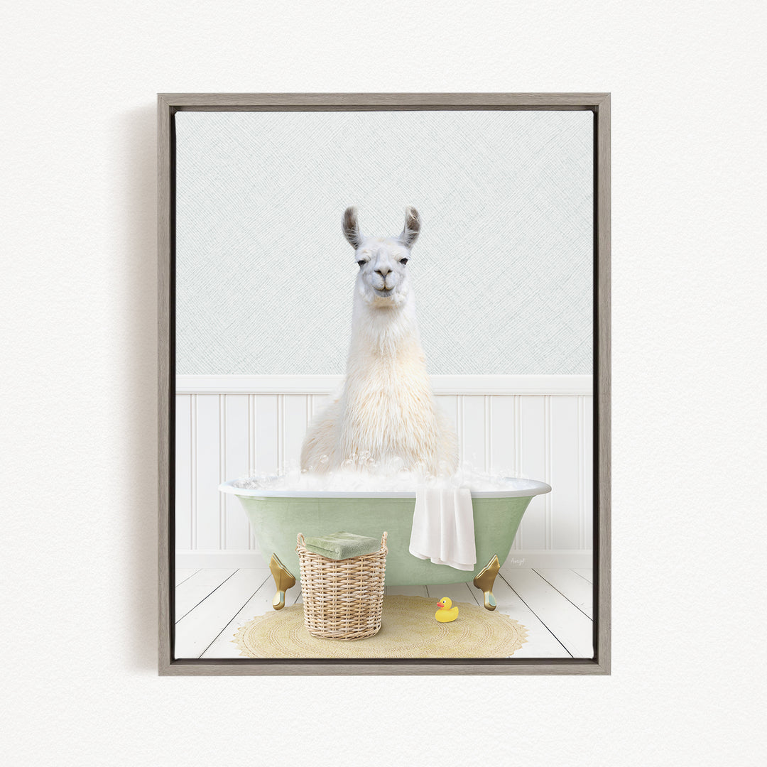 A white llama sitting in a green bathtub filled with bubbles, surrounded by a basket of bath toys and a yellow rubber duck.