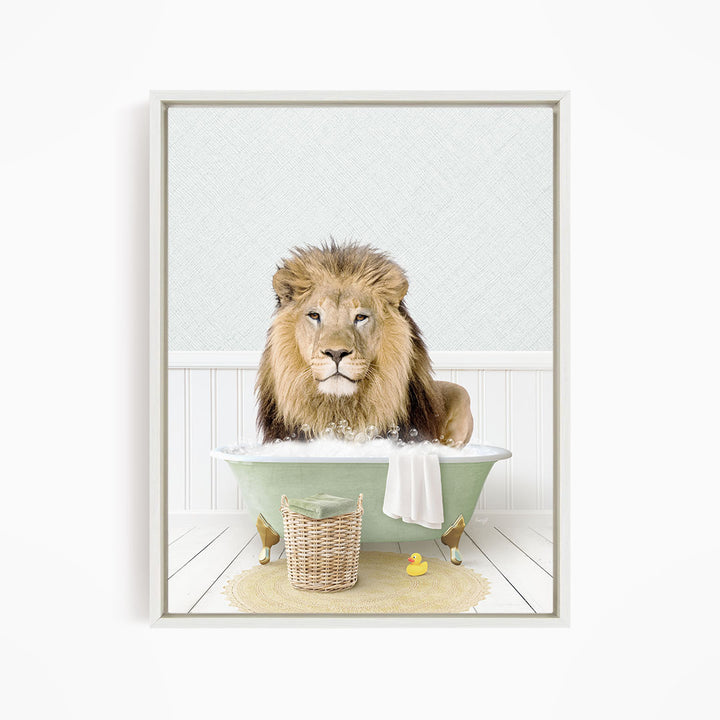 A lion sitting in a green bathtub filled with water, surrounded by a basket of toys and a yellow rubber duck.