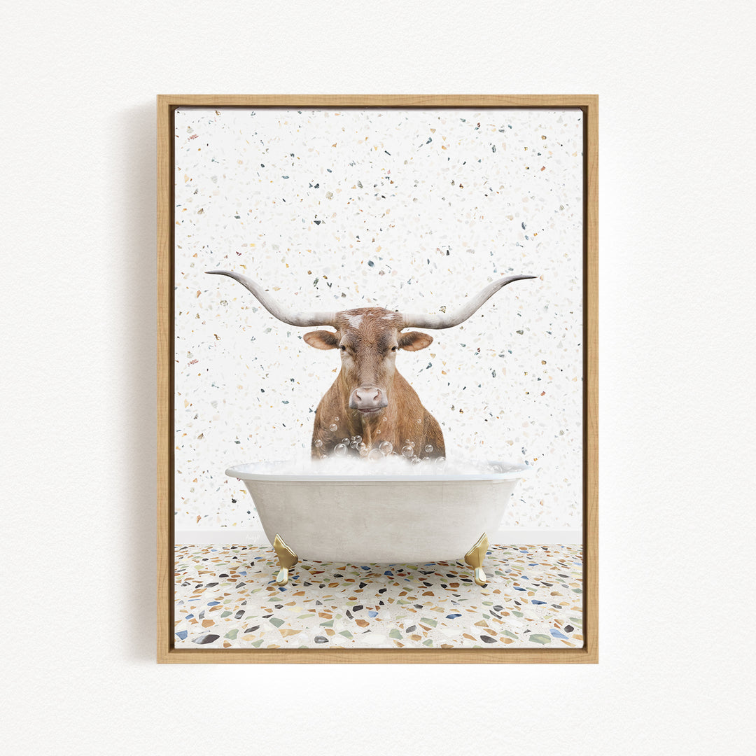 A brown cow with large horns is sitting in a white bathtub filled with water, surrounded by a speckled floor.