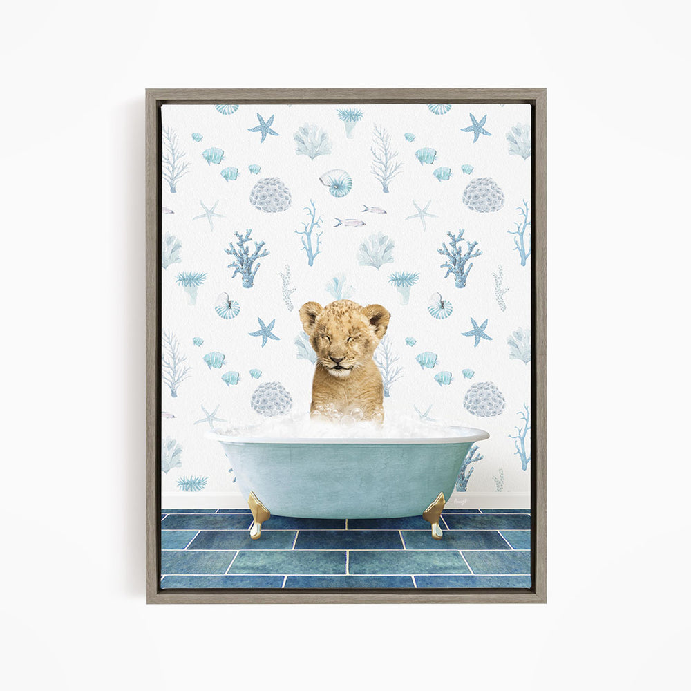 A young lion cub is sitting in a blue bathtub filled with water, surrounded by a pattern of seashells, starfish, and other marine life.