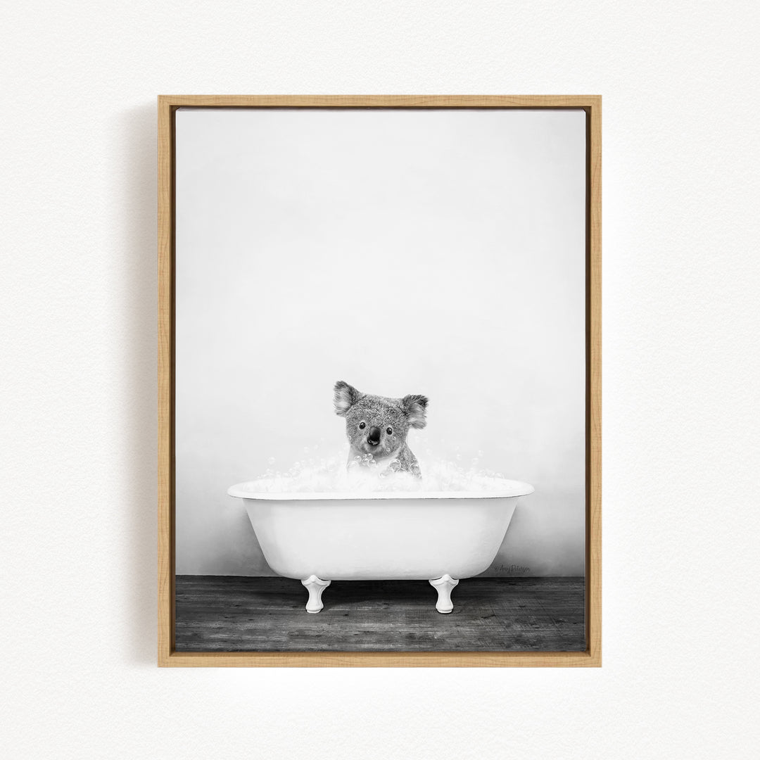 A koala is sitting in a white bathtub filled with water, creating a playful and whimsical scene.