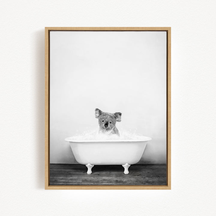 A koala is sitting in a white bathtub filled with water, creating a playful and whimsical scene.