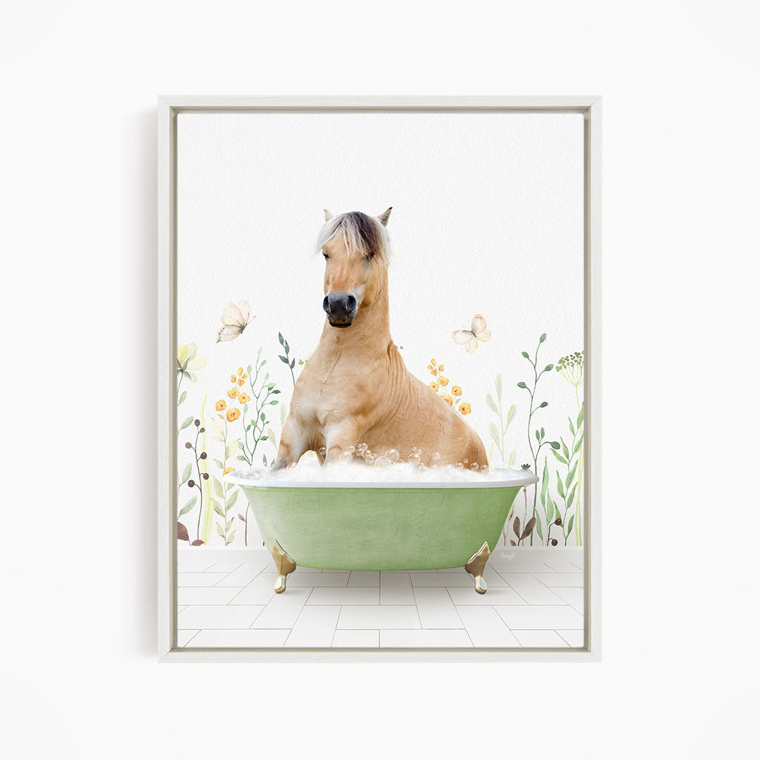A light brown horse is sitting in a green bathtub filled with bubbles, surrounded by flowers and butterflies.
