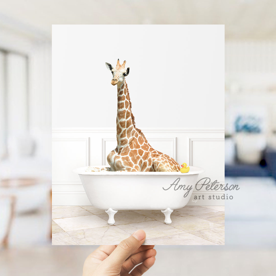 a giraffe sitting in a bathtub with a person holding up a card