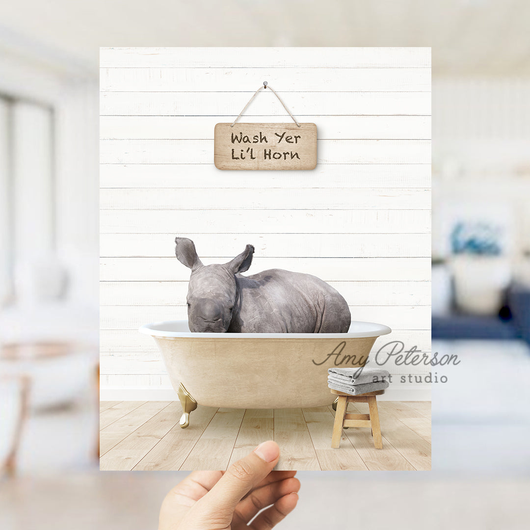 a rhino in a bathtub with a sign hanging above it