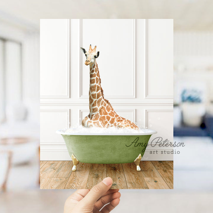 a giraffe sitting in a bathtub with a hand holding it