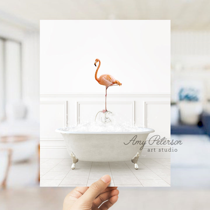 a person holding a card with a flamingo in a bathtub