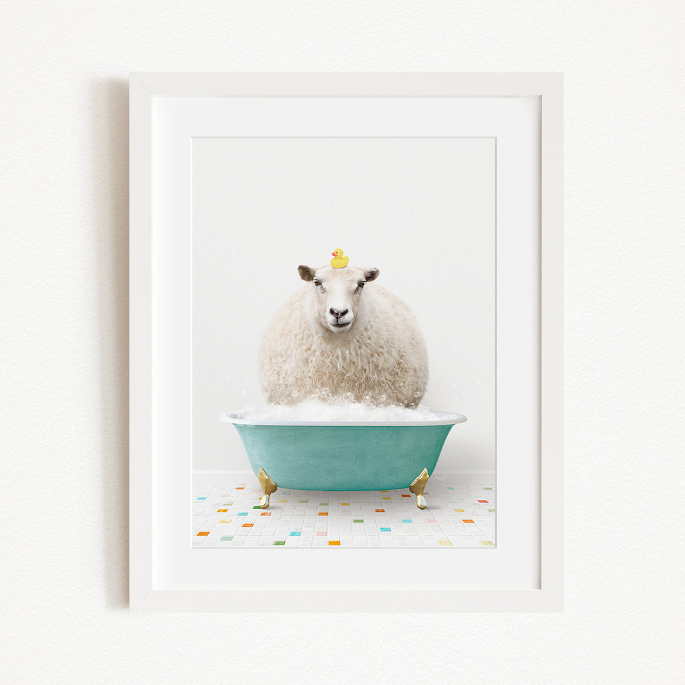 A fluffy white sheep sits in a blue bathtub, with a yellow rubber duck perched on its head.