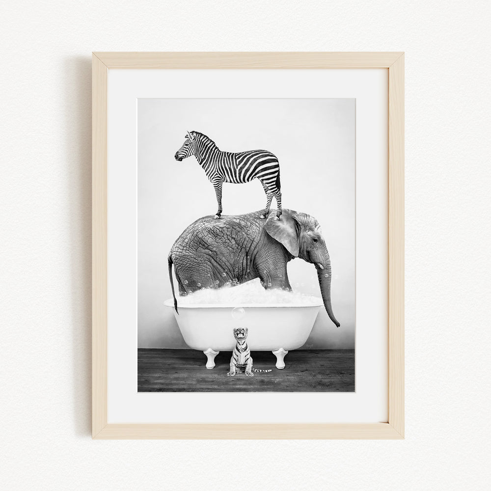 A zebra stands atop an elephant in a bathtub, with a small tiger sitting in the tub below.