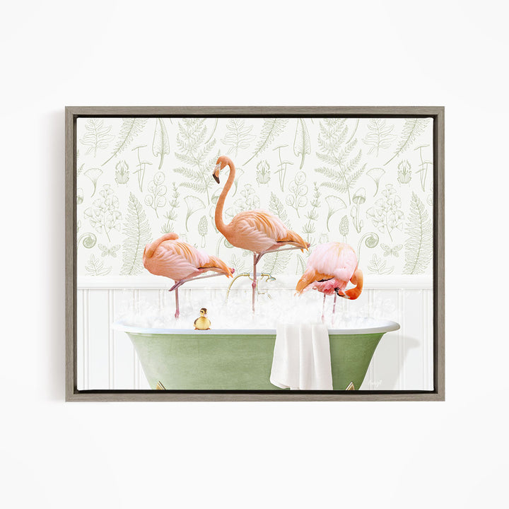A framed image depicting three pink flamingos standing in a green bathtub filled with water, with a small yellow bird sitting in the water.