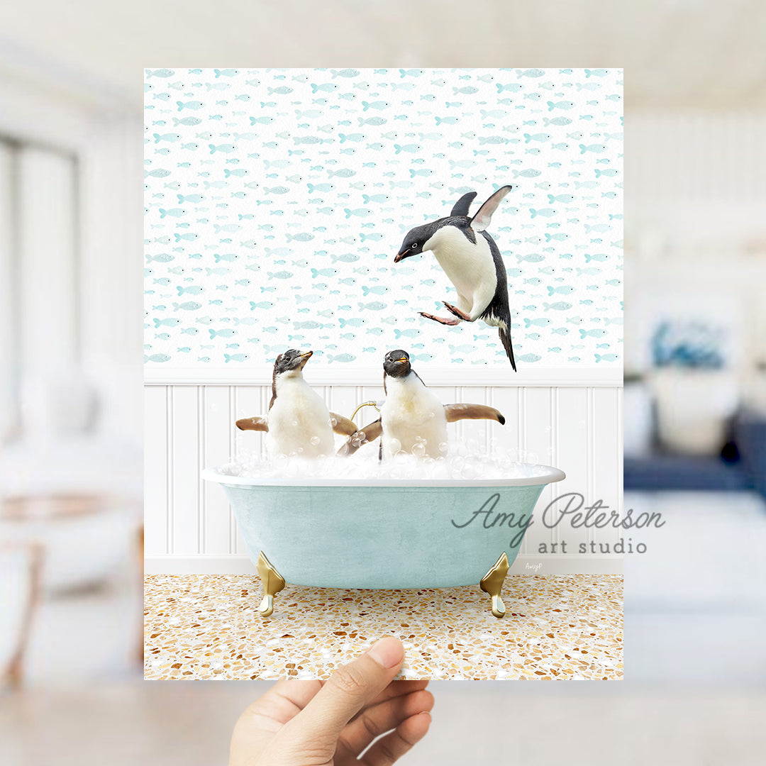 a hand holding up a card with penguins in a bathtub