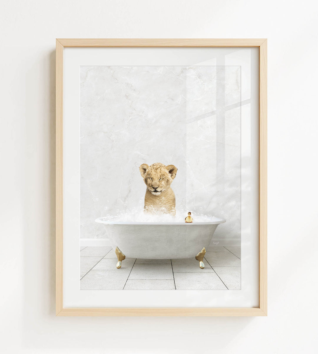 A young lion cub sitting in a bathtub filled with bubbles, surrounded by a few rubber ducks.