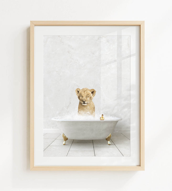 A young lion cub sitting in a bathtub filled with bubbles, surrounded by a few rubber ducks.