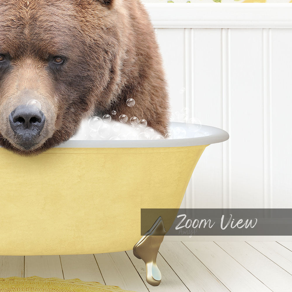 A close-up of a brown bear sitting in a yellow bathtub filled with bubbles, with a white wall and wooden floor in the background.
