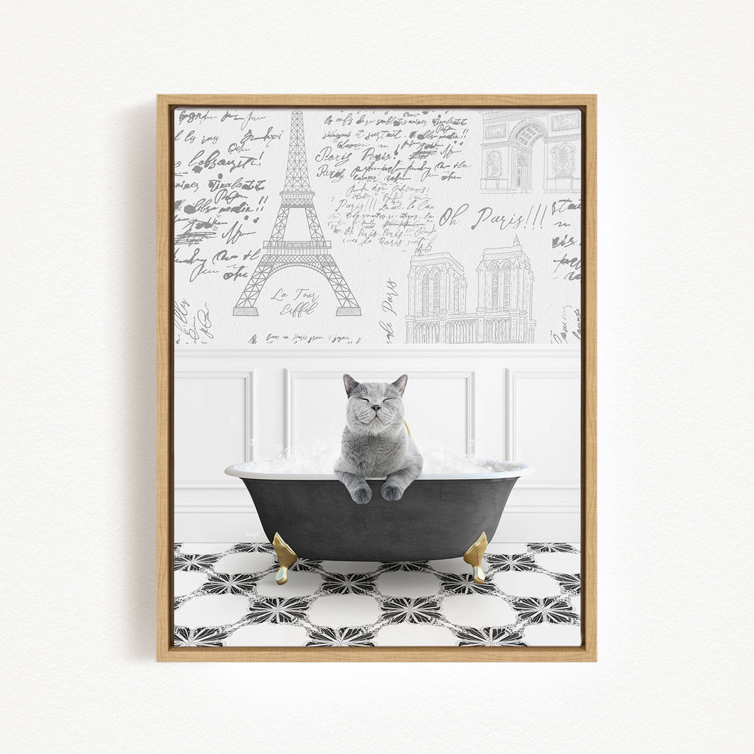 A gray cat sitting in a bathtub filled with bubbles, with the Eiffel Tower and other Parisian landmarks visible in the background.