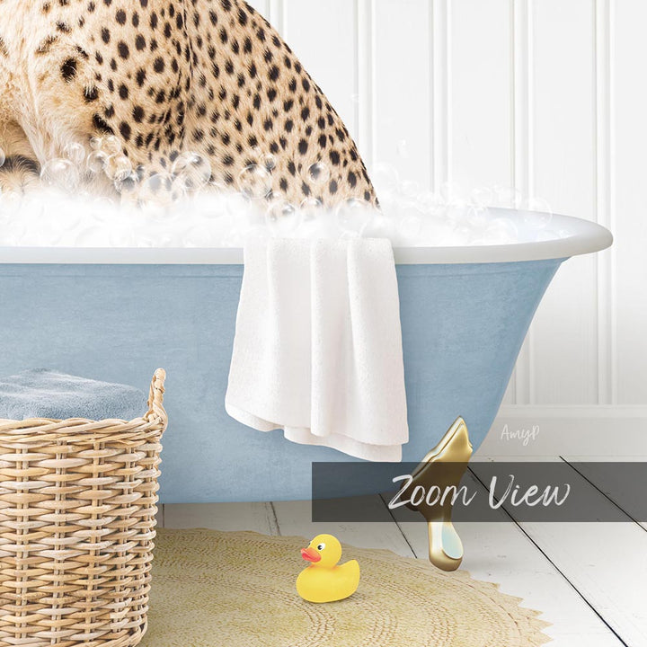 A cheetah is sitting in a blue bathtub filled with water, surrounded by a yellow rubber duck and a white towel.