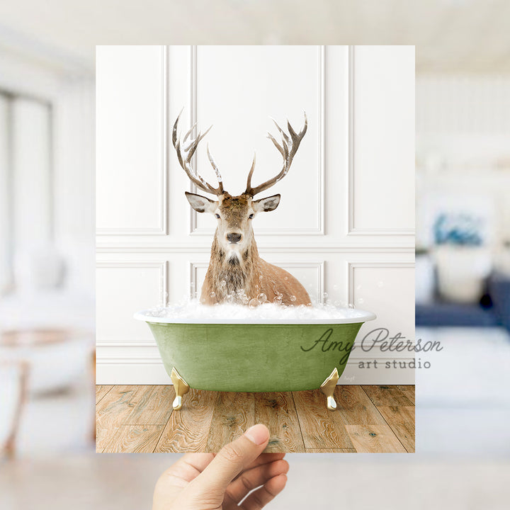 a hand holding a card with a picture of a deer in a bathtub