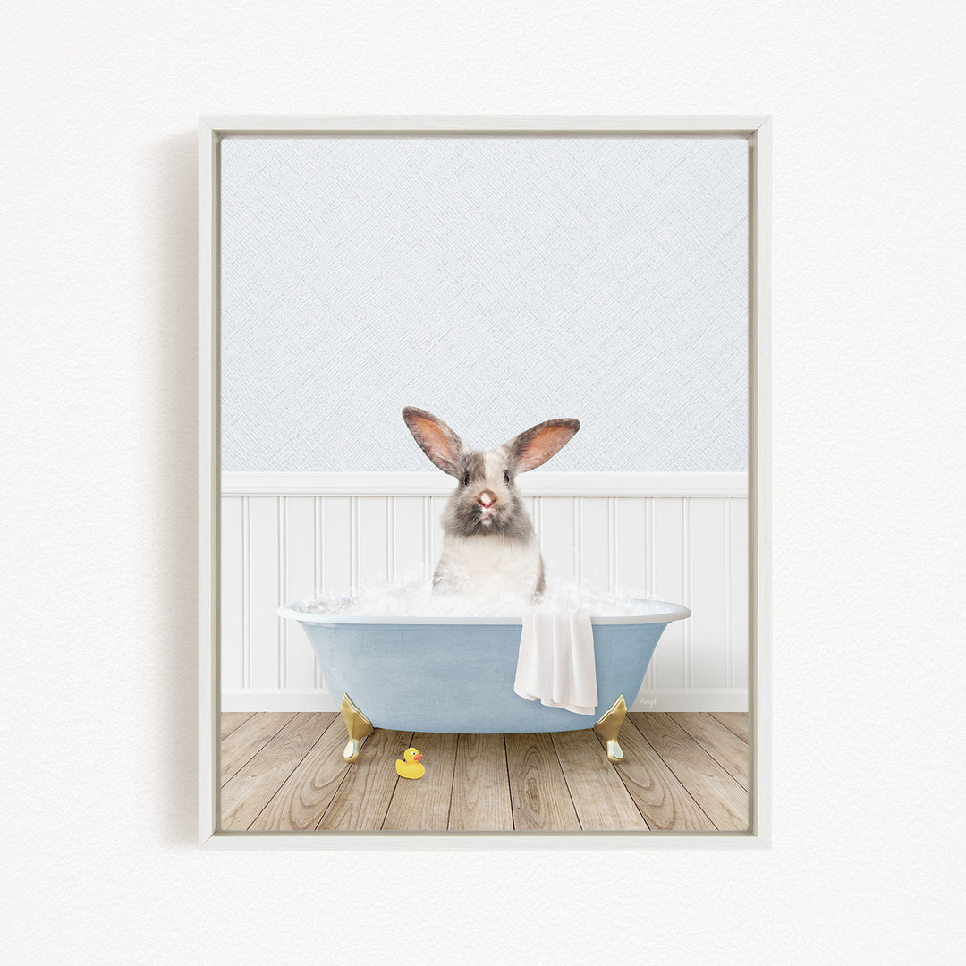 A white rabbit sitting in a blue bathtub filled with water, surrounded by rubber duckies.