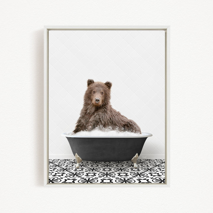 A brown bear sitting in a black bathtub filled with bubbles, with a black and white patterned floor in the background.