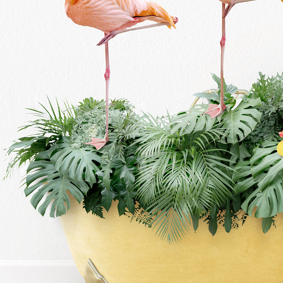 two flamingos standing on top of a plant pot