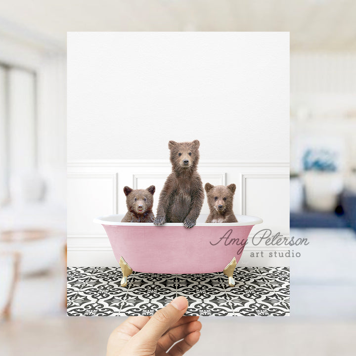 a person holding a card with three bears in a bathtub