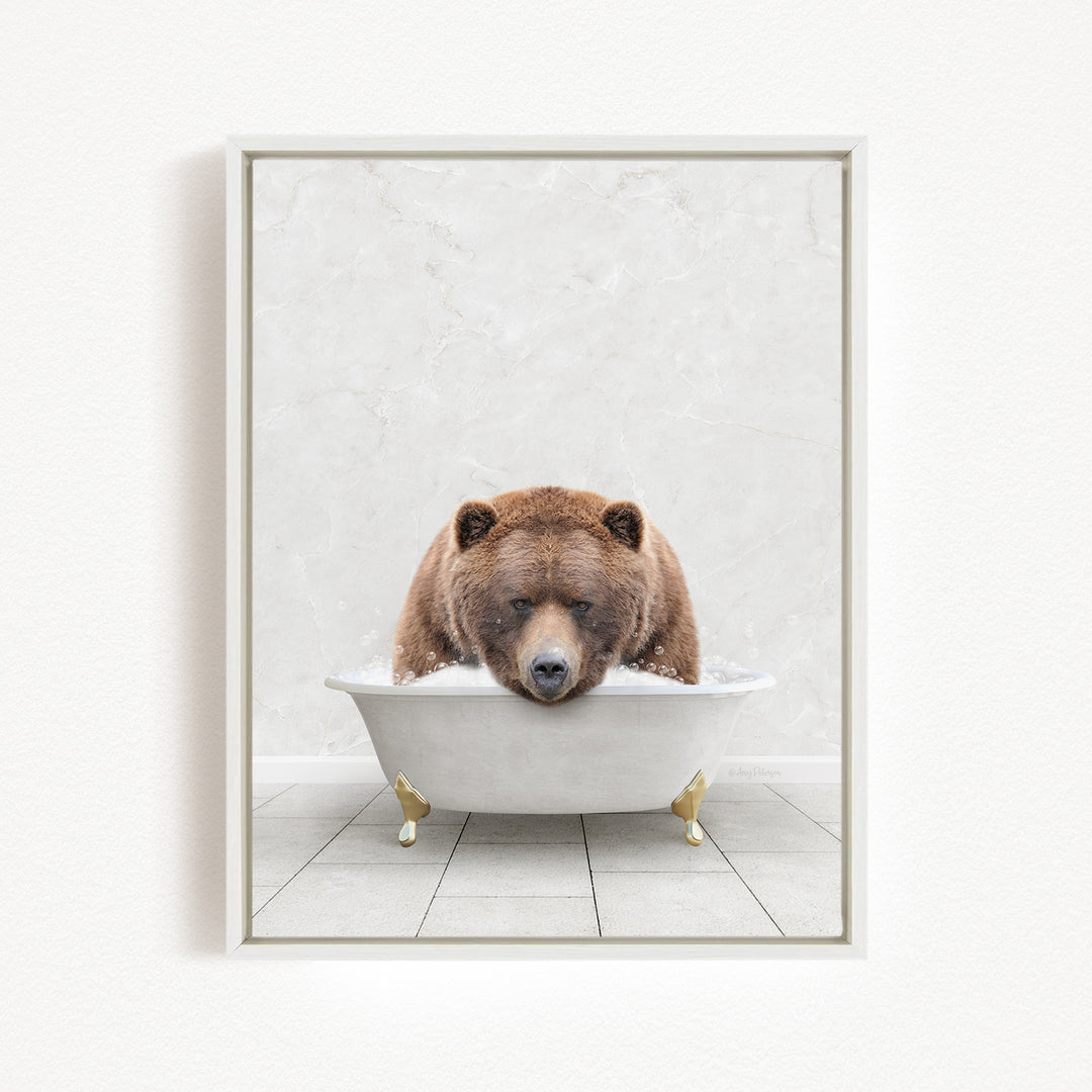 A brown bear is sitting in a white bathtub, appearing relaxed and content.