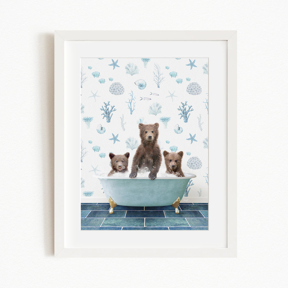 Three brown bears sitting in a blue bathtub, surrounded by a blue and white ocean-themed wallpaper.