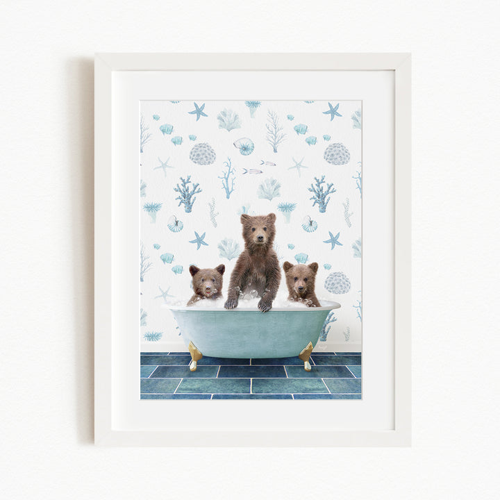 Three brown bears sitting in a blue bathtub, surrounded by a blue and white ocean-themed wallpaper.