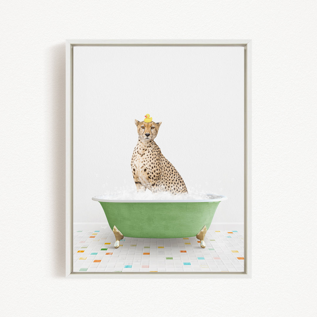 A cheetah sitting in a green bathtub filled with bubbles, with a yellow rubber duck perched on its head.