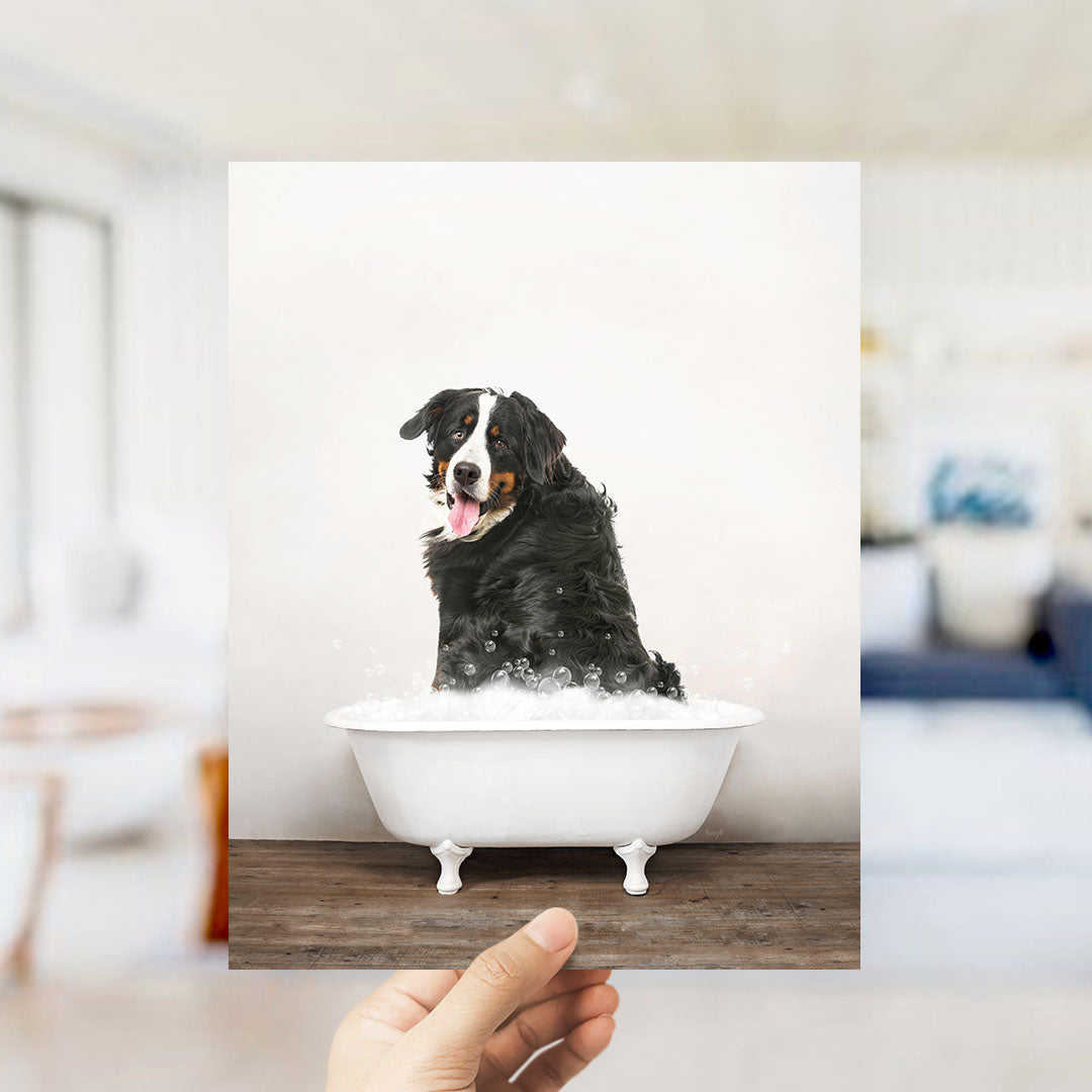 A black and white dog sitting in a white bathtub filled with bubbles, with a blurred background suggesting a bathroom setting.