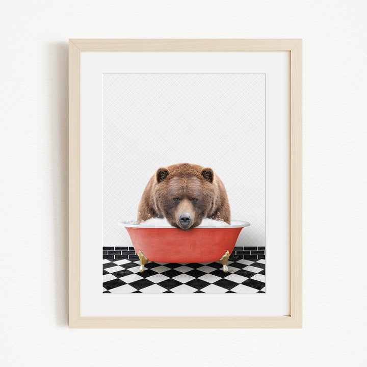 A brown bear is sitting in a red bathtub filled with water, appearing to be enjoying a relaxing bath.
