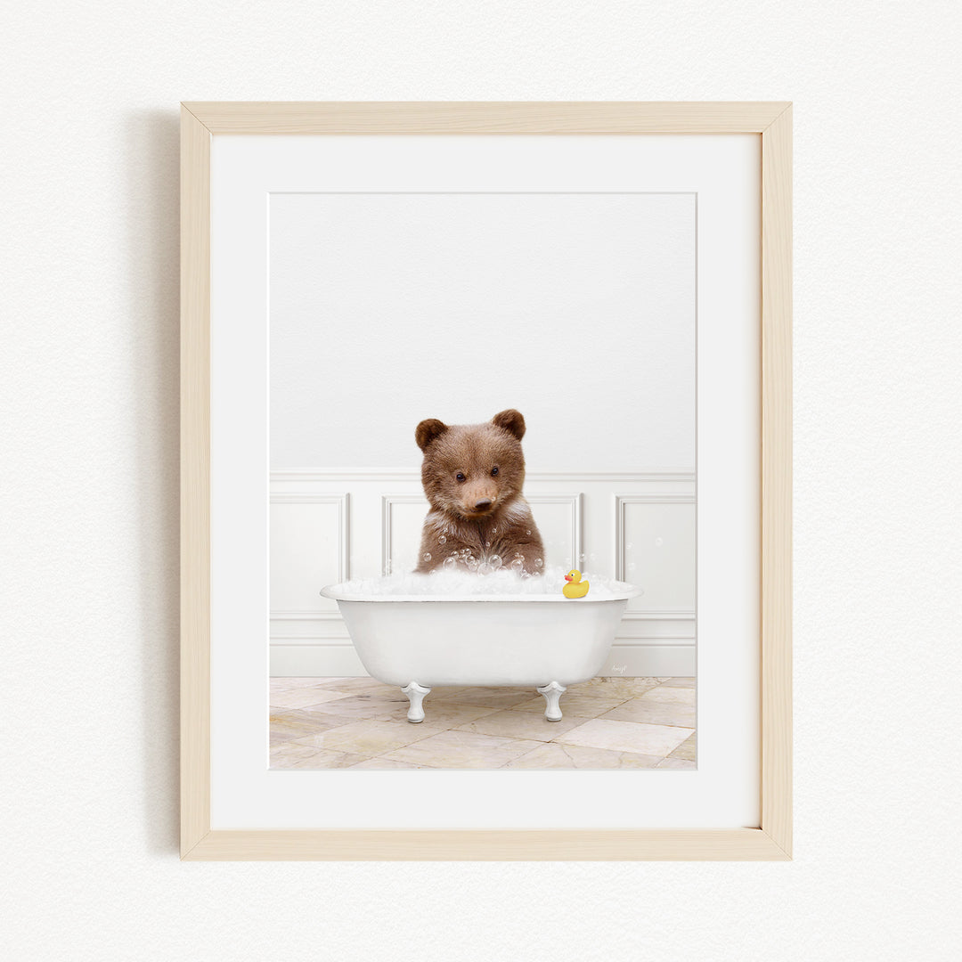 A brown bear sitting in a white bathtub filled with water, with a yellow rubber duck floating in the water.