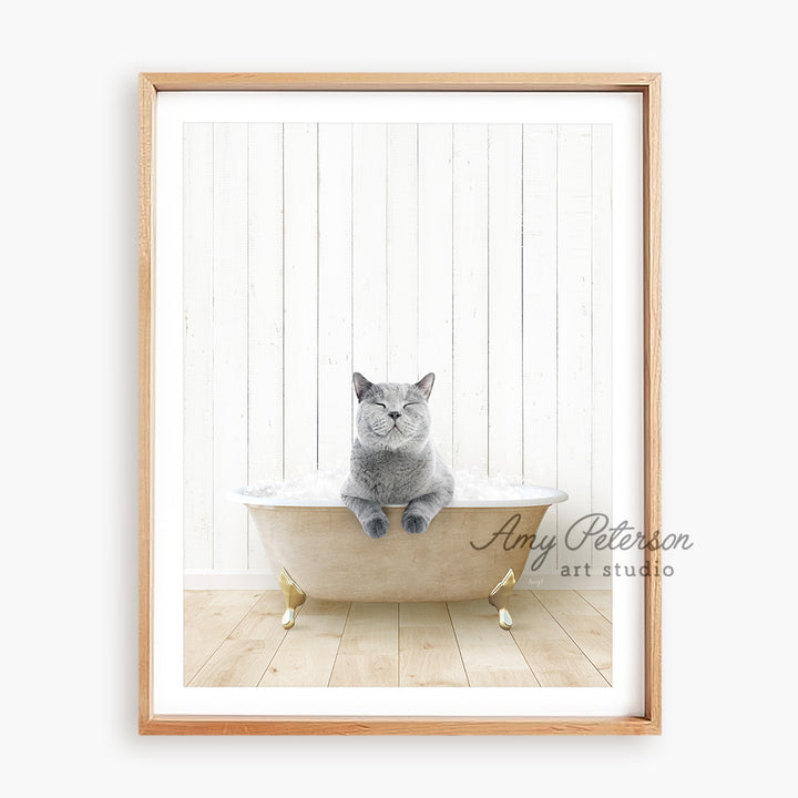 a cat sitting in a bathtub on a wooden floor