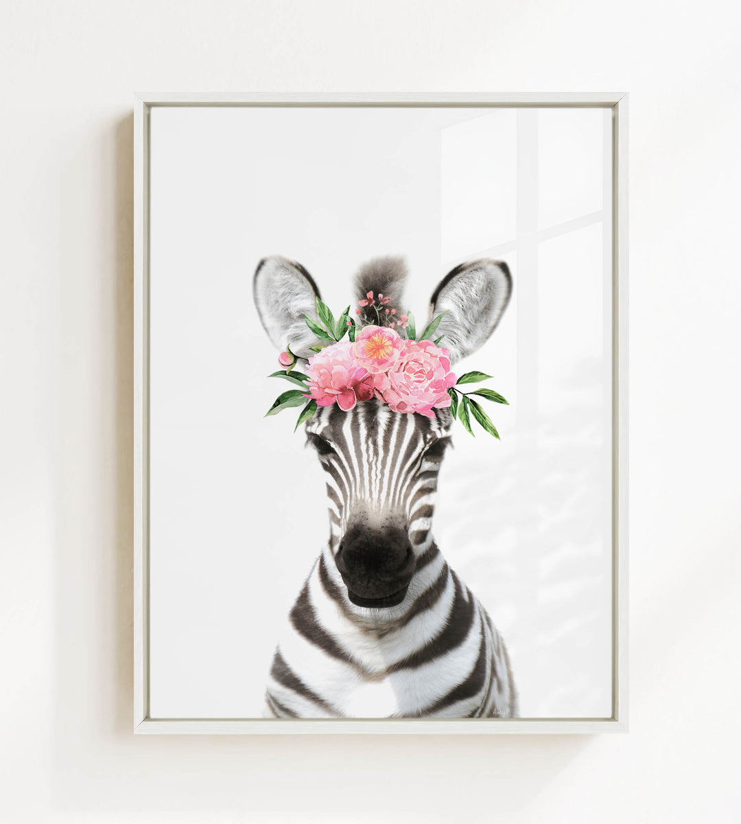 A zebra wearing a floral headpiece with pink flowers and green leaves.