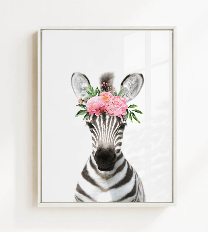 A zebra wearing a floral headpiece with pink flowers and green leaves.