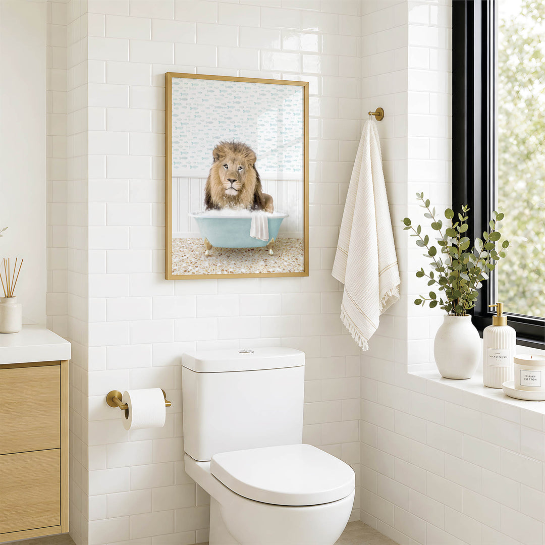 a bathroom with a white toilet, a framed picture of a lion in a bathtub, and a towel hanging on the wall.